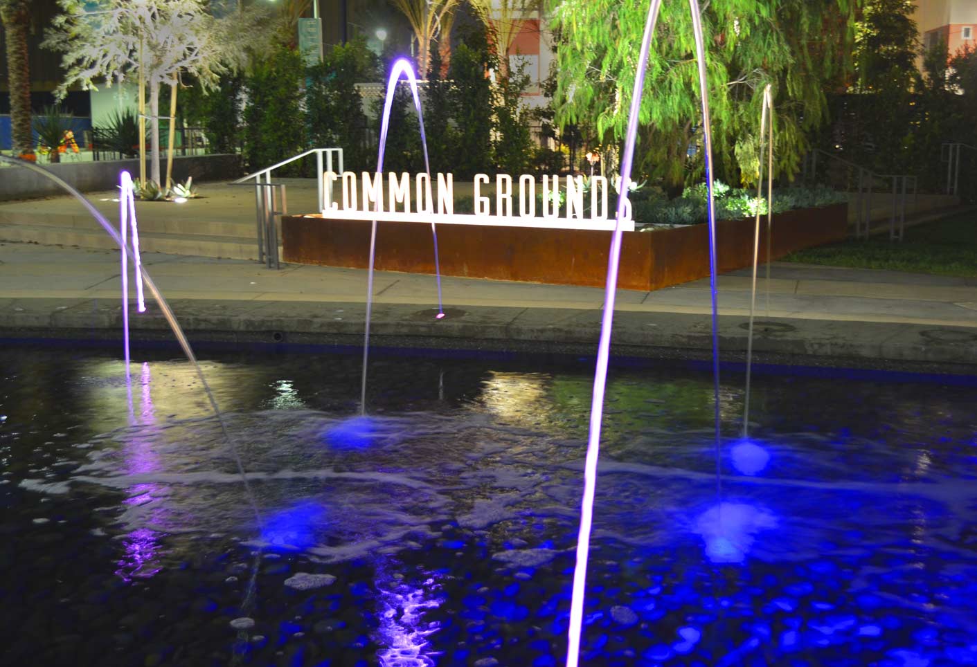 Community Development Water Feature at night with sign